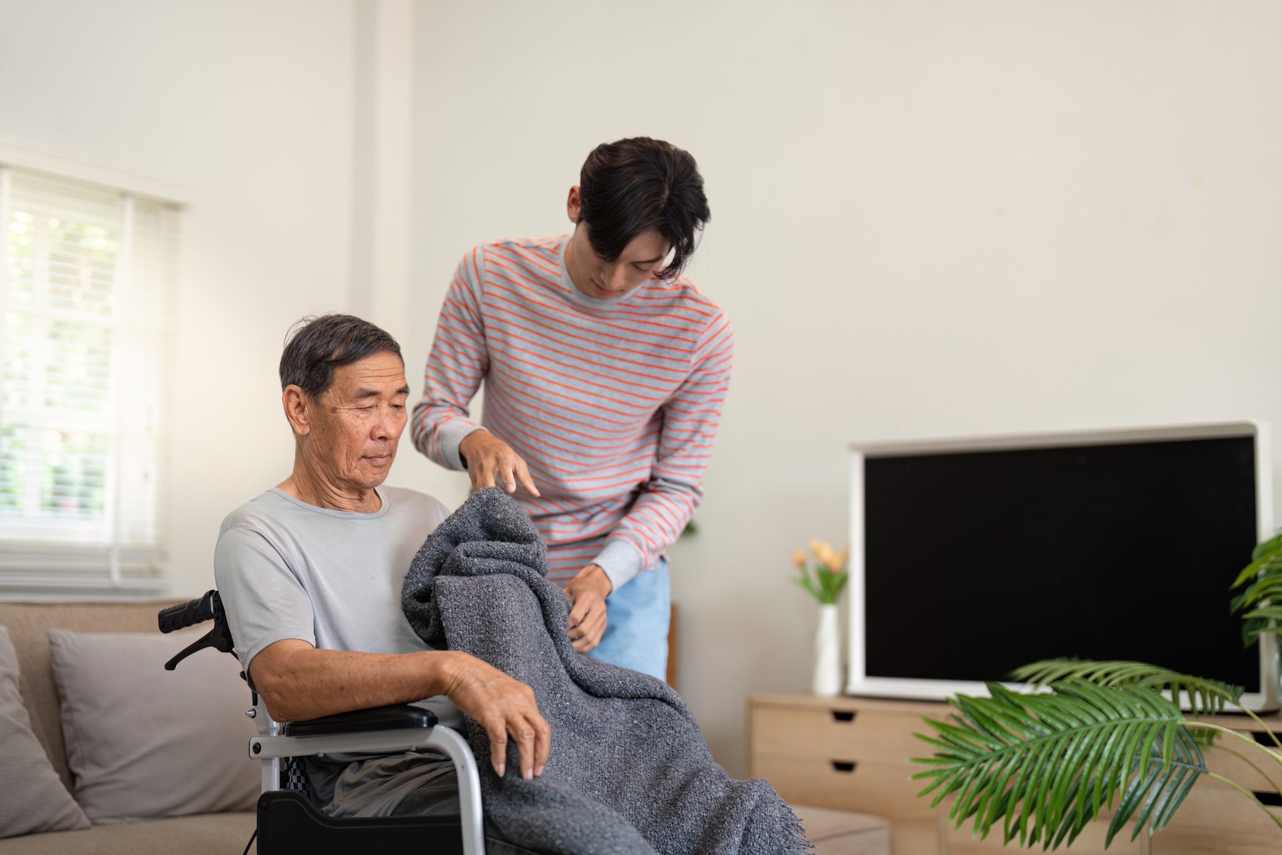 Son covering elderly father